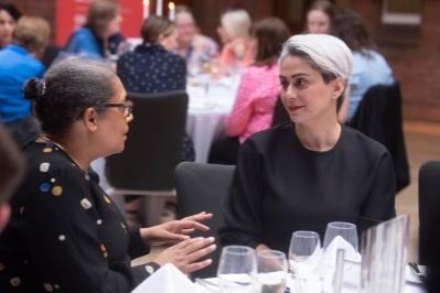 Two ladies talking at dinner table